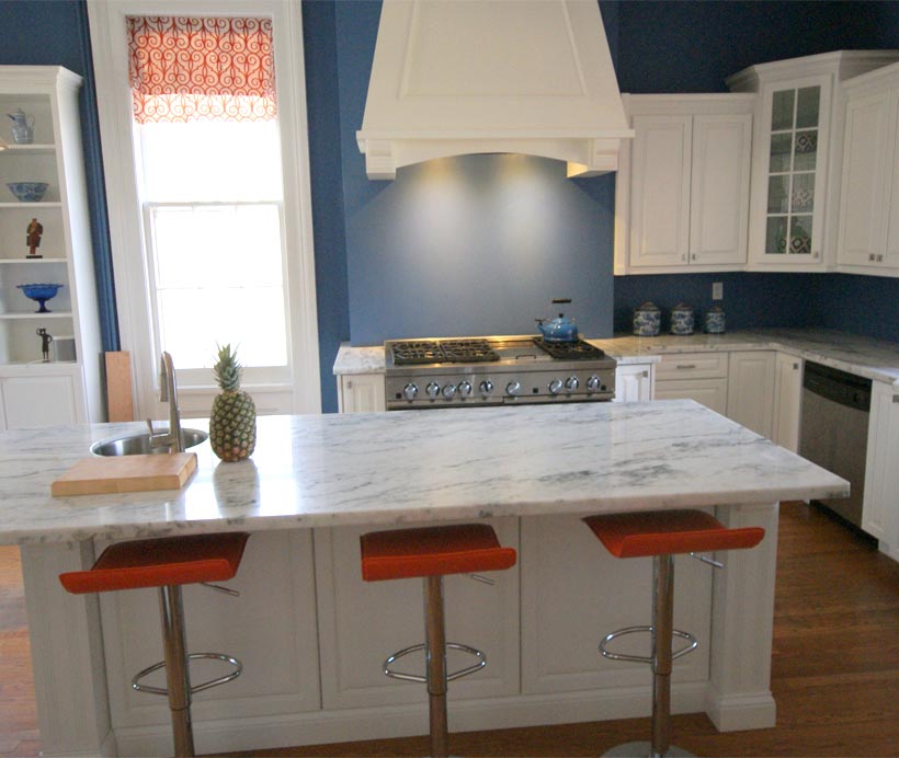 Kitchen cabinets, range hood, and island counter